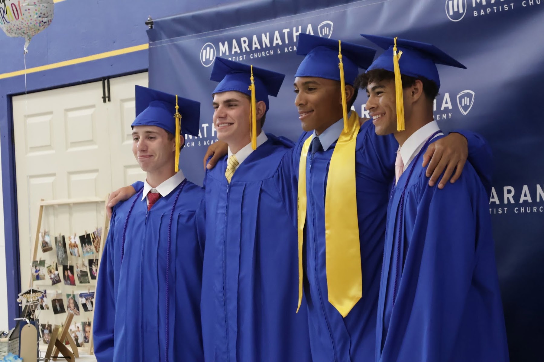Maranatha graduates celebrating in navy and gold